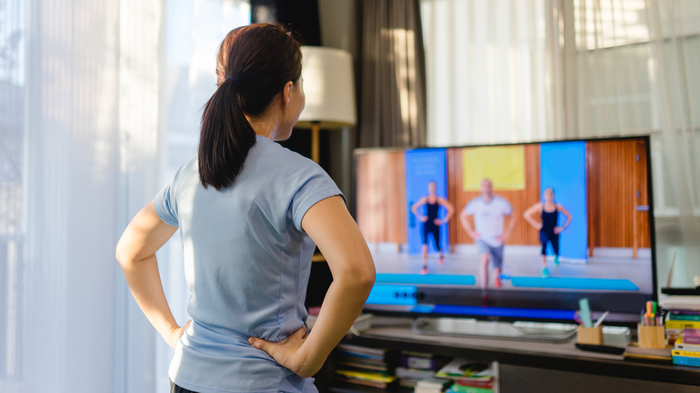 Woman working out with TV