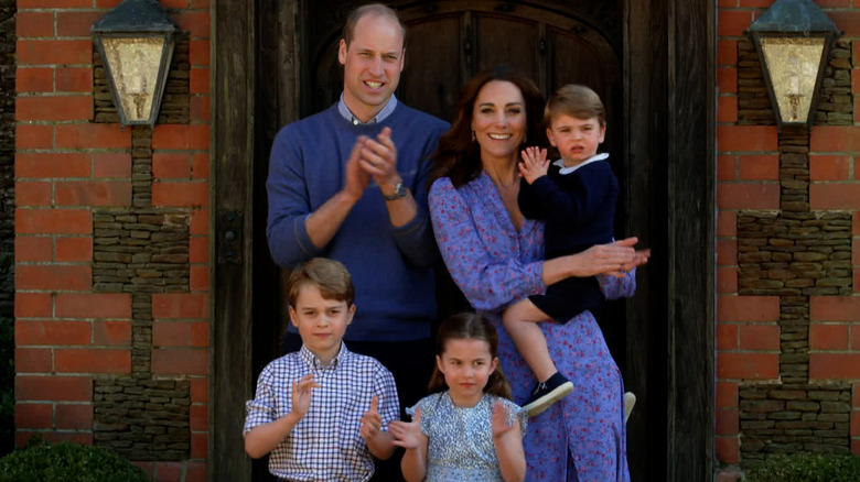 Prince William, Princess Kate, and their children posing 