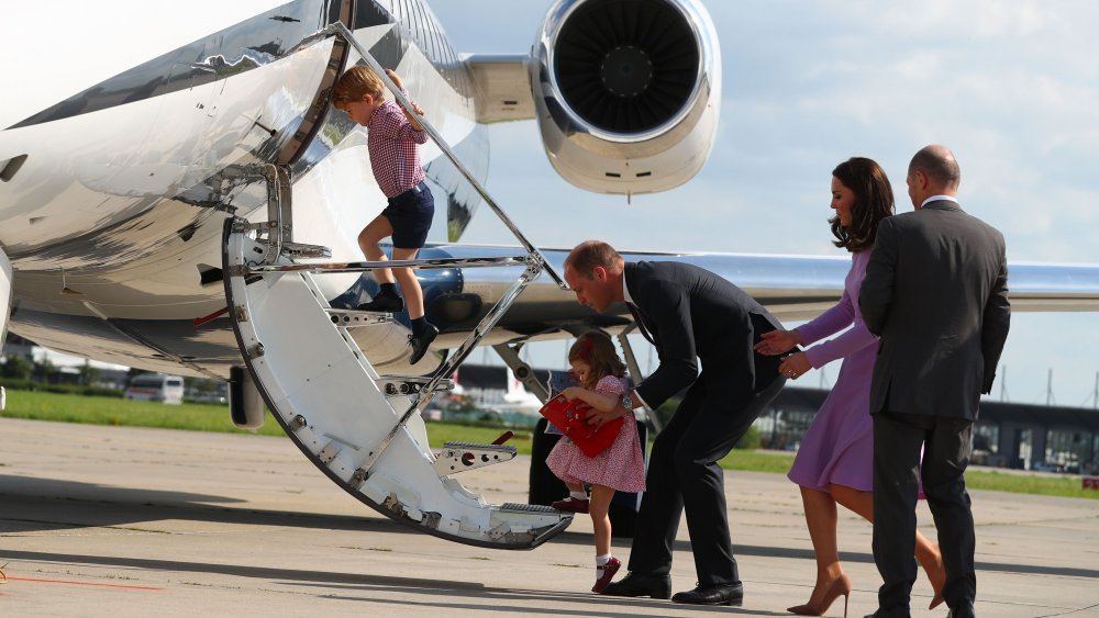 William and Kate and their children boarding a plane