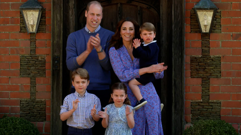 William and Catherine clapping with their children