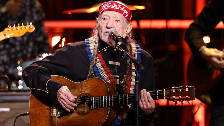 Willie Nelson performing on stage