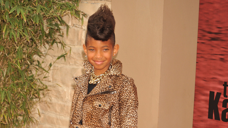 Young Willow Smith smiling wearing cheetah print jacket