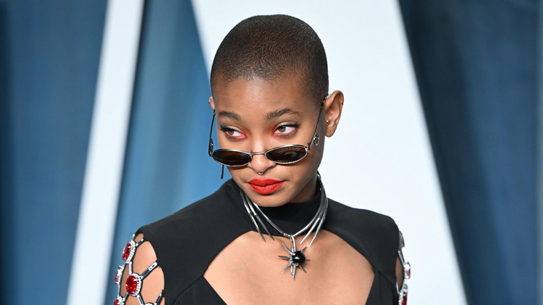 Willow Smith on red carpet wear sunglasses and red lipstick