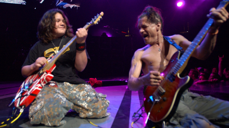 Wolfgang Van Halen playing on stage with Eddie Van Halen