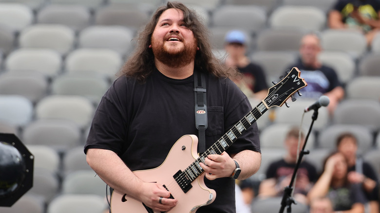 Wolfgang Van Halen holding guitar on stage