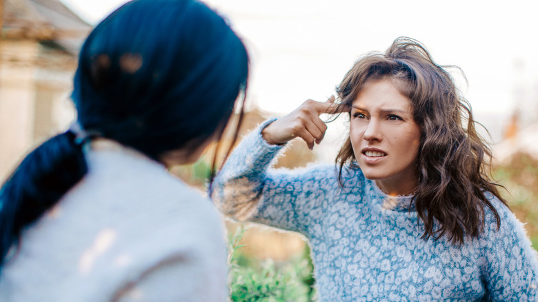 Angry women arguing outside