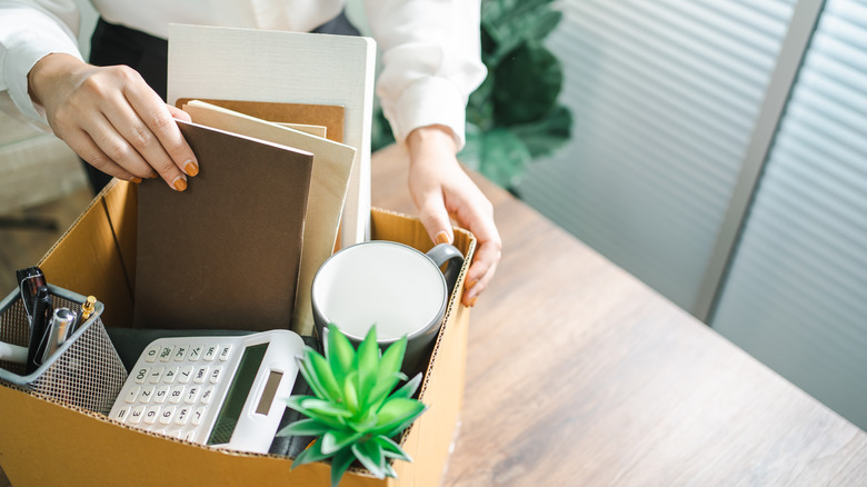 Woman packing up her office, resigning