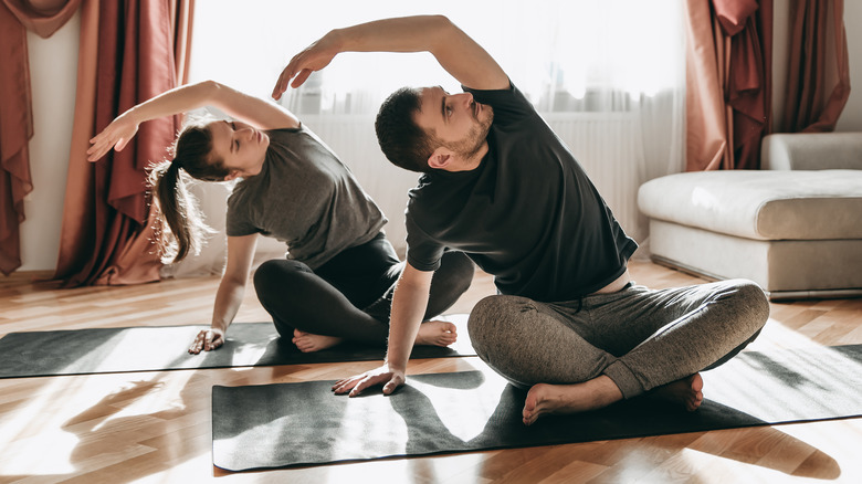 couple practicing yoga pose together