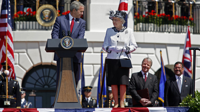 Queen Elizabeth II next to George W. Bush giving speech