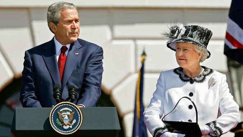 Queen Elizabeth II looking at President George W. Bush