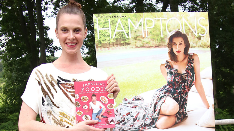 Elettra Wiedemann holding cookbook