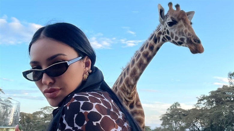 Bre Tiesi poses with giraffe