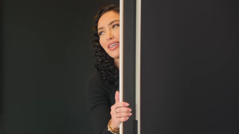 Bre Tiesi peeking out of door