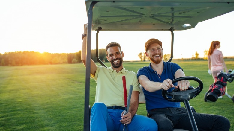 Two men in golf cart on golf course