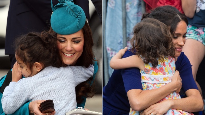 Meghan Markle and Kate Middleton hugging visitors 