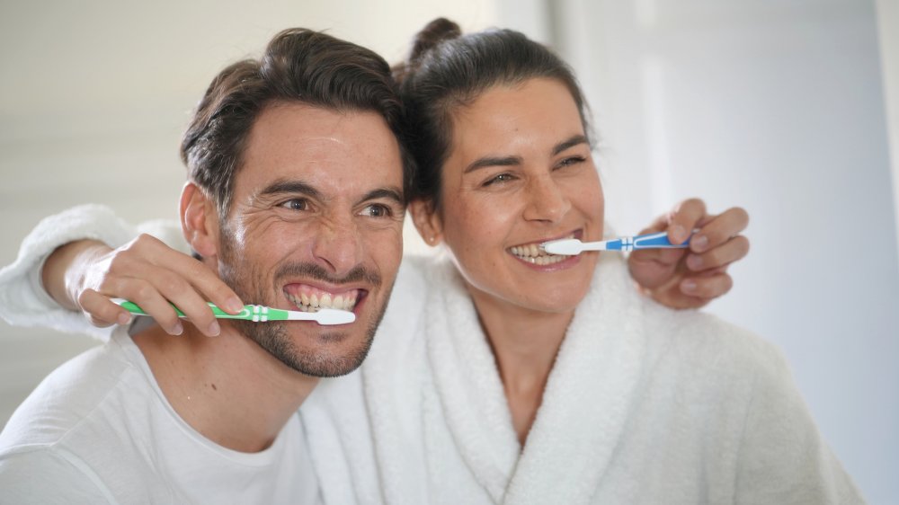 couple brushing teeth