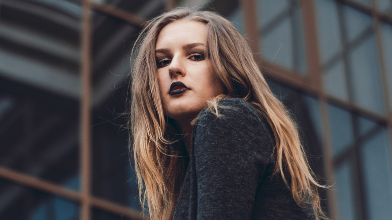 woman with black lipstick wearing all black