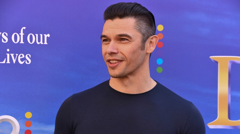 Paul Telfer poses for photos on the red carpet. 