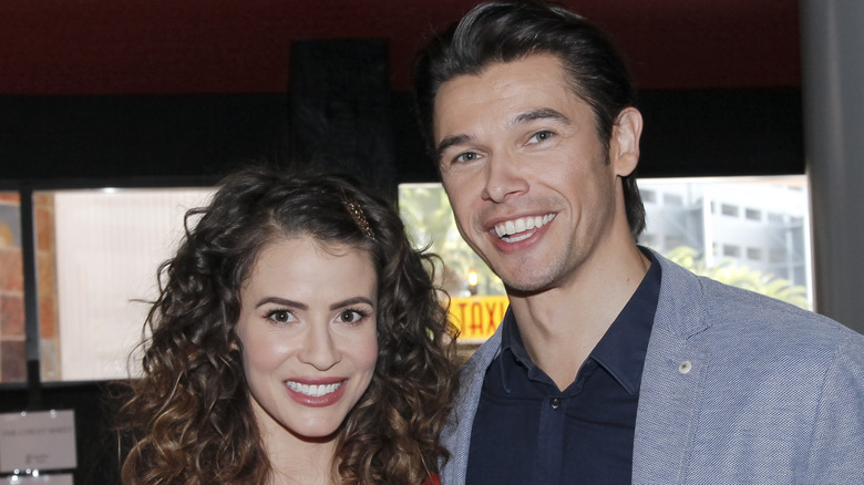 Linsey Godfrey and Paul Telfer smiling