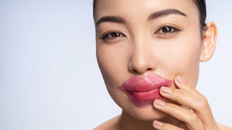 A woman using a lip mask