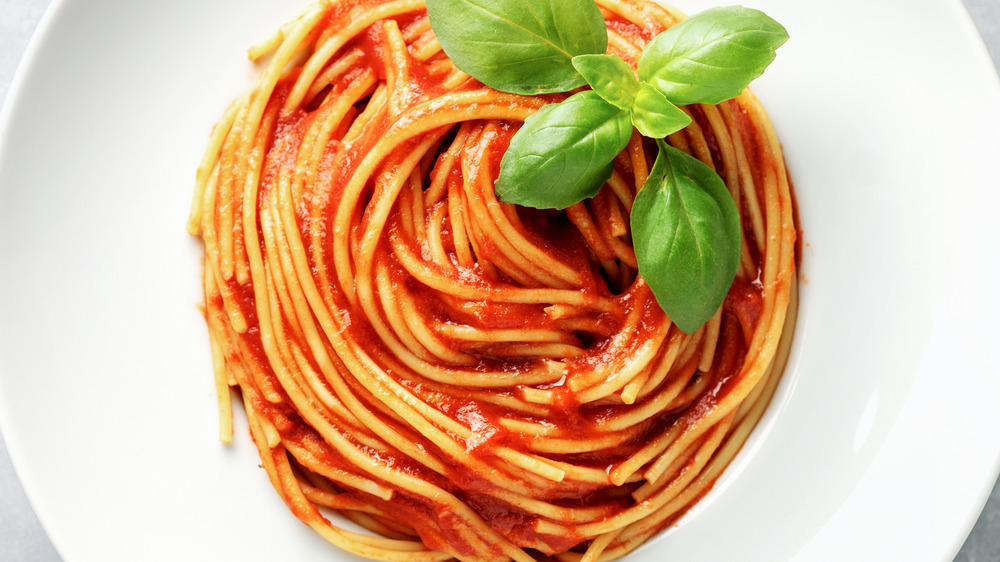 pasta with red sauce in a white bowl 