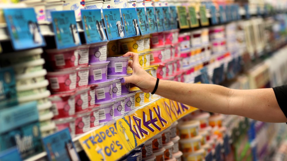 a woman reaching for yogurt