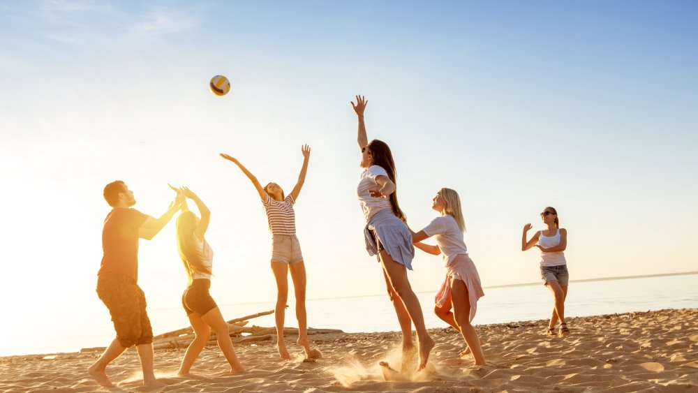 Beachgoers playing beach volleyball