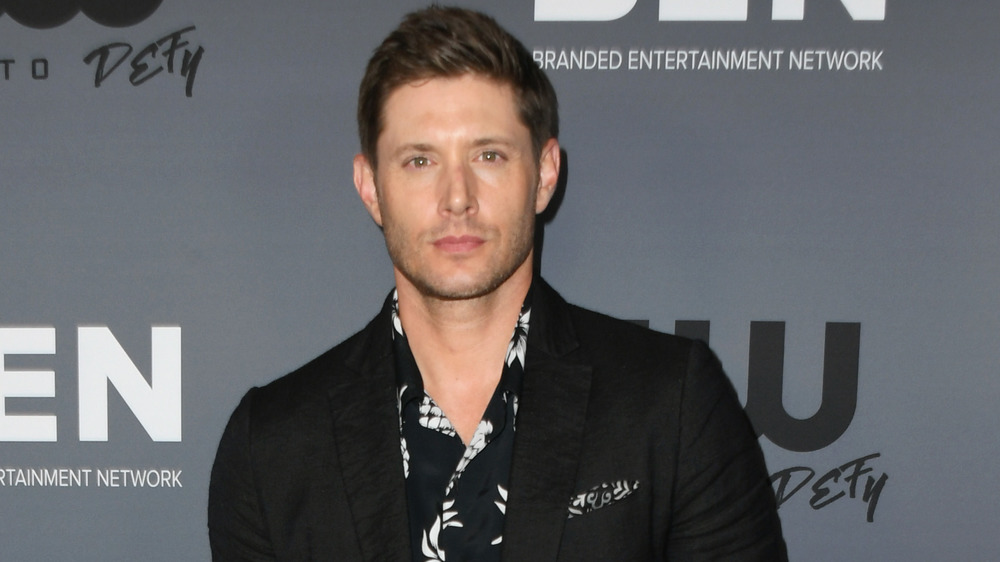 Jensen Ackles wears a black blazer and printed shirt