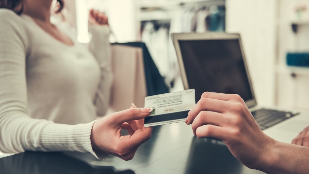 girl using credit card to pay for a purchase