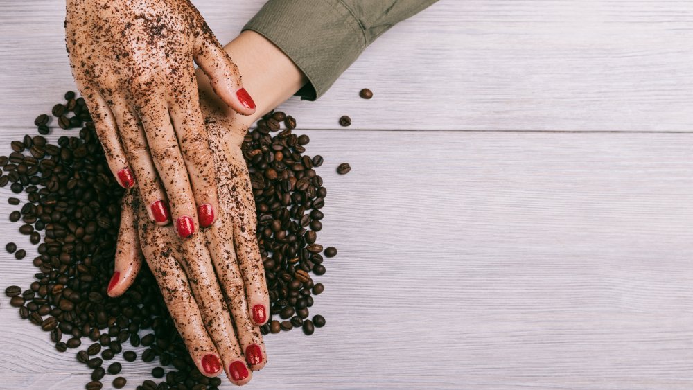 Scrubbing hands with coffee grounds