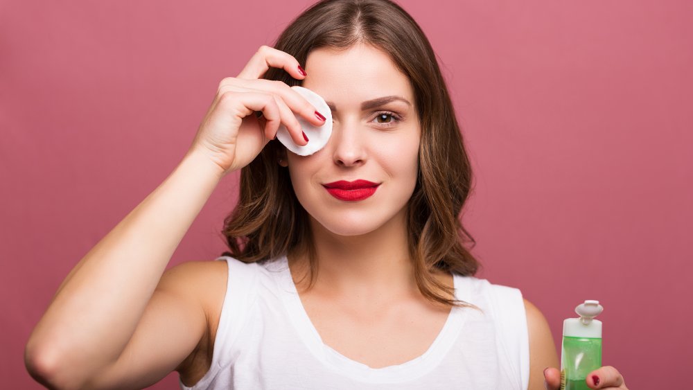 Woman using skin toner