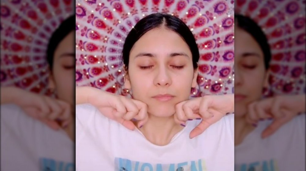 Person doing face yoga