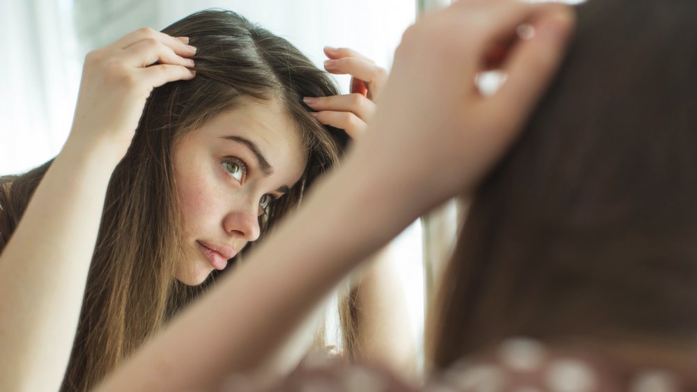 Woman checking scalp