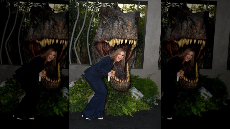 Ariana Richards pretends to be eaten by a T-rex