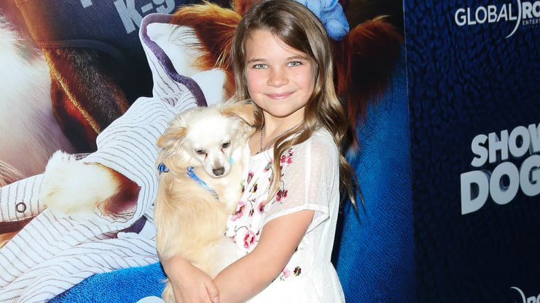 Raegan Revord holding a dog