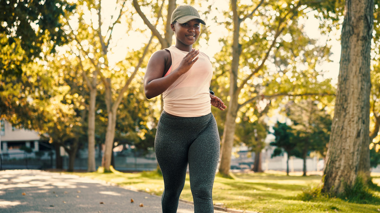 Woman running wearing cap