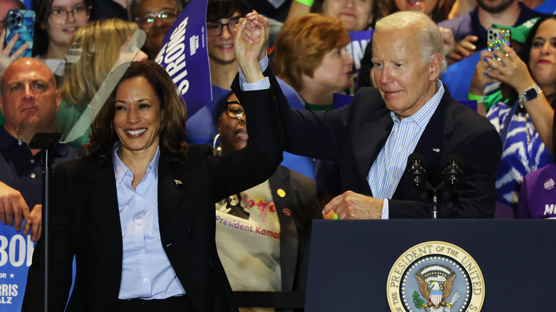 Joe Biden lifting Kamala Harris' hand