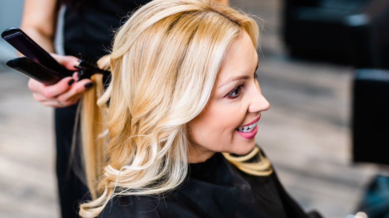 Middle-aged woman getting dyed hair done