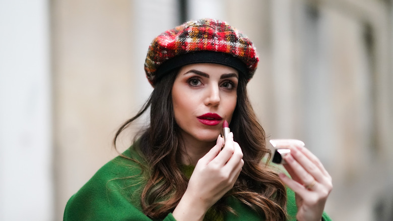 Model wearing beret with lipstick