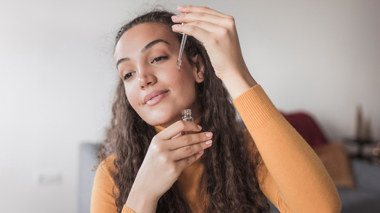 Woman putting on serum