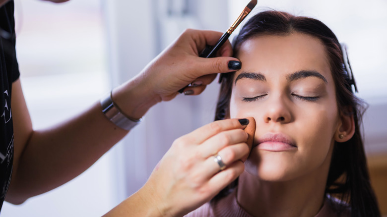 Woman applying foundation