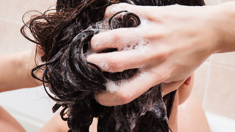 Woman shampooing her hair