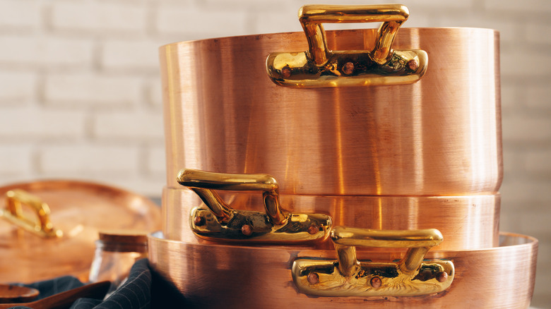 A stack of copper pots and pans