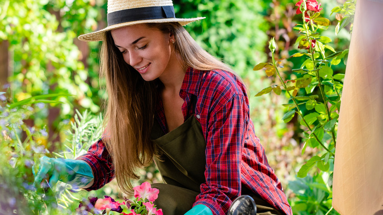 Woman gardening with gloves on