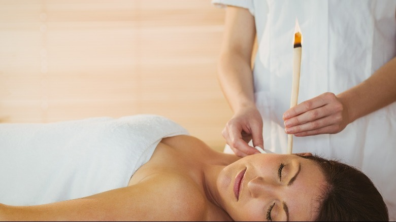 Woman getting ear candling