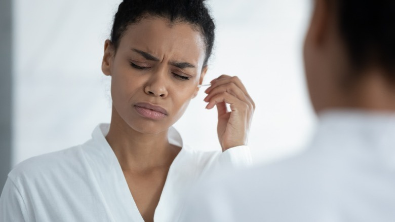 Woman frowning with Q-tip