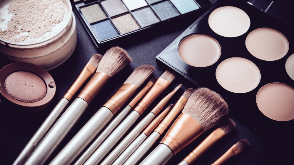 makeup brushes next to makeup