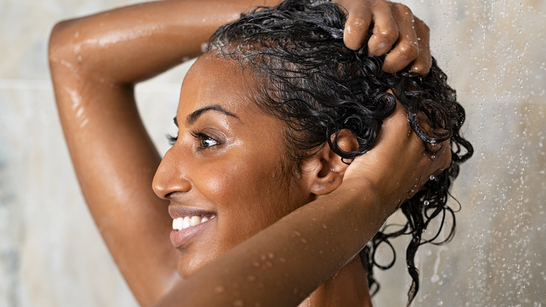 Woman washing hair in shower 