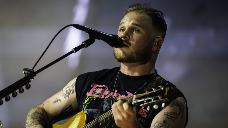 Zach Bryan playing guitar