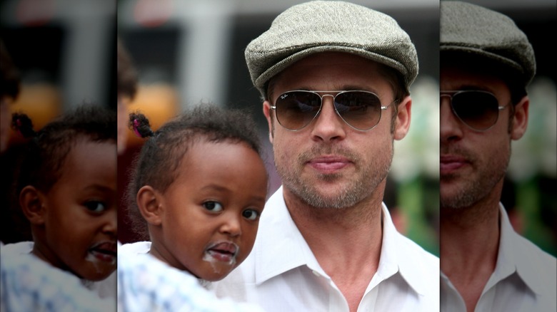 young zahara jolie-pitt being carried by brad pitt